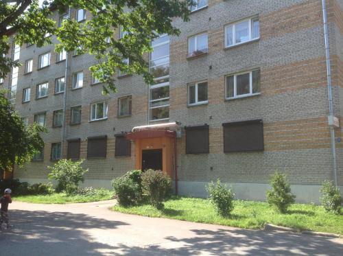 a brick building with a person on a bike in front of it at Yulia Apartment in Narva