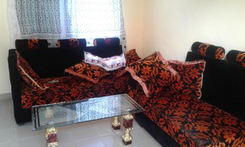 a living room with a couch and a chair at JJ & JE Family House in Dar es Salaam