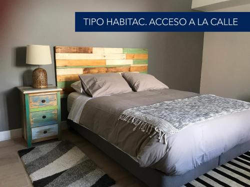 a bedroom with a bed and a side table at Hotel El Milagro in Pisco Elqui