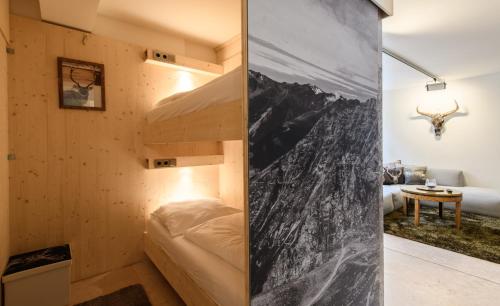 a small bedroom with a bunk bed in a wooden room at Kaiser Max Design Appartements in Innsbruck