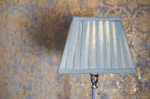 a blue lamp sitting next to a wall at Grays Court Hotel in York