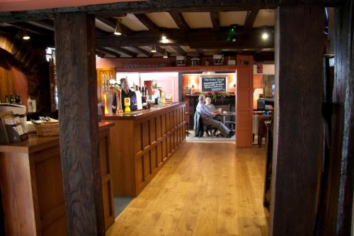 a bar with a person sitting at a counter at The Globe in Exeter