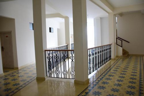 a hallway of a building with blue and white tiles at Hotel Med Barranquilla Centro in Barranquilla