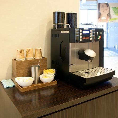 a coffee maker on top of a counter with bowls at Super Hotel Kushiro-Ekimae in Kushiro