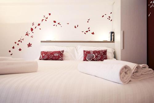 a bedroom with two beds with birds on the wall at Suite Fiera Milano City in Milan