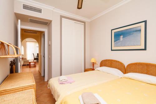 - une chambre avec deux lits, une table et une chaise dans l'établissement Carabeo 52 Apartments Casasol, à Nerja