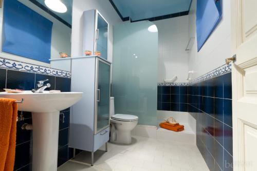 a blue bathroom with a sink and a toilet at Armapana in Barcelona