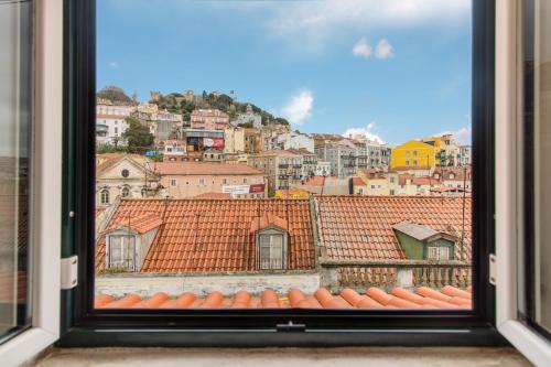 a view of a city from a window at Casa Mouraria in Lisbon