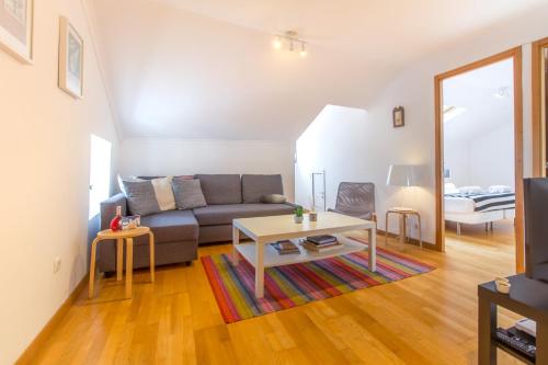 a living room with a couch and a table at Casa Mouraria in Lisbon