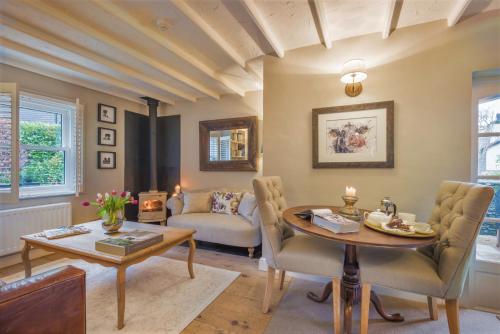 a living room with a table and a couch at Haven Cottage in Ambleside