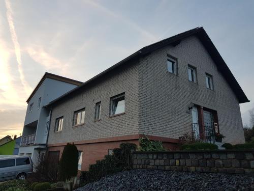 a large brick house with a fence in front of it at FeWo Lena in Kinderbeuern