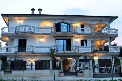 a large white building with balconies on top of it at B&B Rosa dei Venti in Roseto Capo Spulico