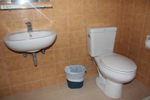 a bathroom with a toilet and a sink at Elegant Circle Inn in Cebu City