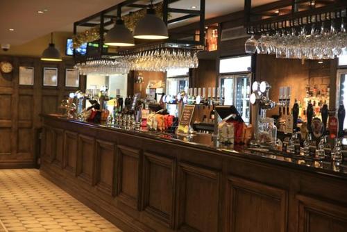 a bar with a lot of bottles and glasses at The Troll Cart Wetherspoon in Great Yarmouth