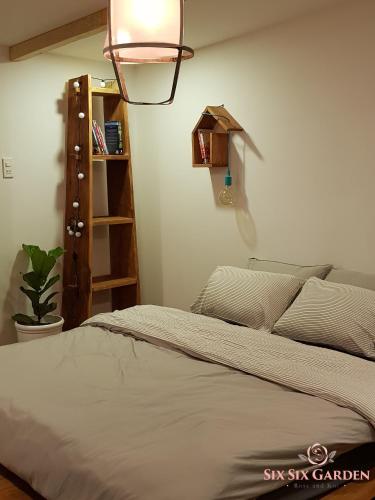 a bedroom with a bed and a book shelf at Six Six Garden in Da Lat