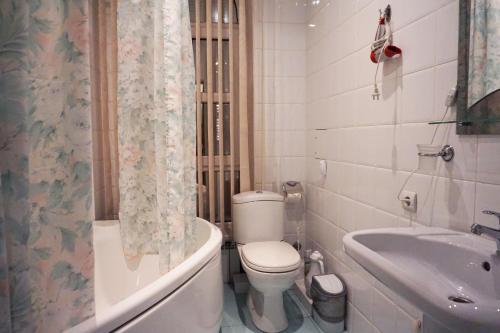 a bathroom with a toilet and a tub and a sink at Hotel Atlantida in Kislovodsk