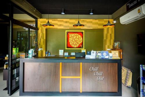 a restaurant with a counter with a sign that says chill chill out at Hobby Hotel in Uttaradit