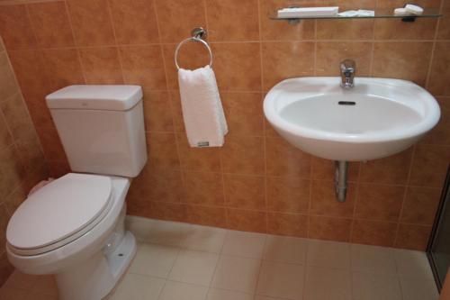a bathroom with a toilet and a sink at Elegant Circle Inn in Cebu City