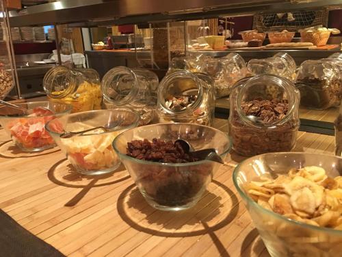 a table with bowls of food in a kitchen at Hotel Bamboo in Coldrano