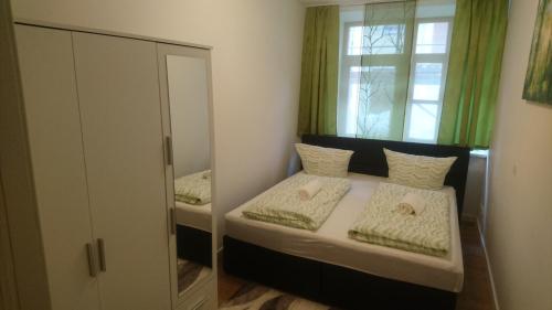 a small bedroom with two beds and a window at Apartment Nürnberg City in Nuremberg