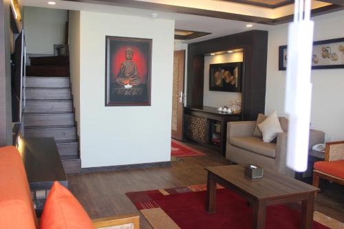 a living room with a couch and a table at Hotel Mystic Mountain in Nagarkot