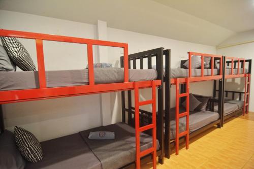 a room with three bunk beds in a room at Lanta Hostel in Ko Lanta