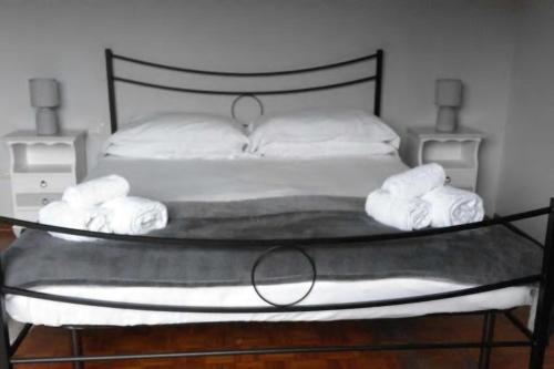 a bedroom with a bed with towels on it at Villa Cristina in Vezzo