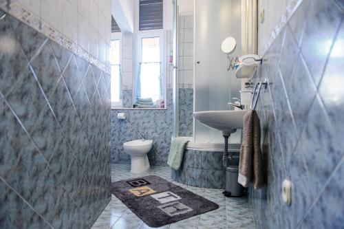 a bathroom with a sink and a toilet at Apartments Marmont in Split