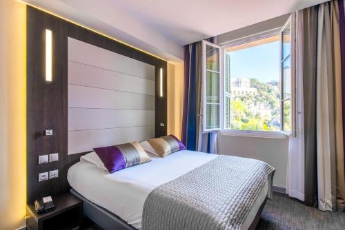 Ένα ή περισσότερα κρεβάτια σε δωμάτιο στο Hotel Le Saint Paul