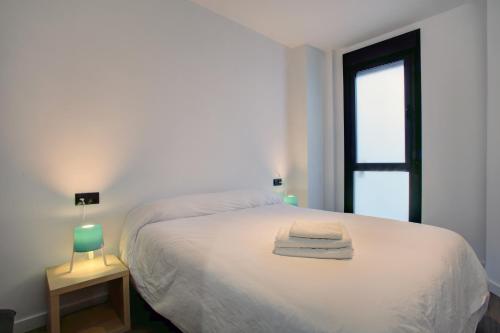 a bedroom with a white bed and a window at Lewis&Peter Apartments Los Remedios in Ronda