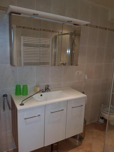 a bathroom with a white sink and a mirror at Gästehaus Ströter in Bacharach