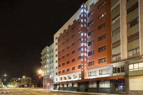 a building with lights on the side of it at night at Crisol Riosol in León