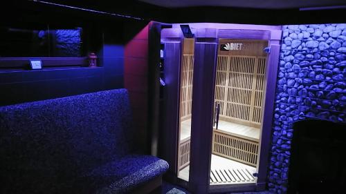 a bird cage in a room with purple lights at Privat LeNa in Ružomberok