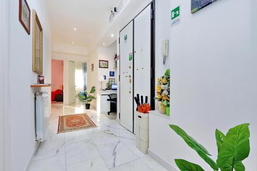 a hallway with white walls and marble flooring at I Pini di Roma - Rooms & Suites in Rome