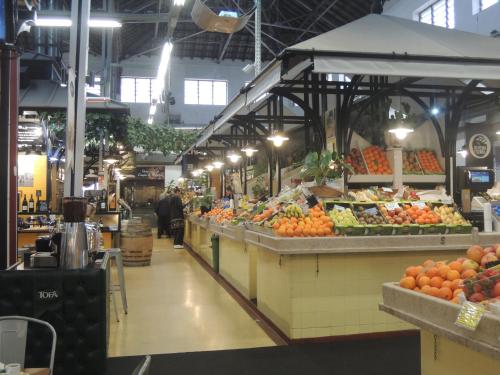 a market with many fruits and vegetables on display at Campo de Ourique Premium in Lisbon