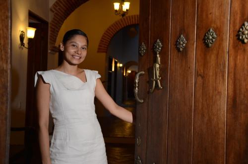 a woman standing in front of a door in a room at Alfiz Hotel in Cartagena de Indias