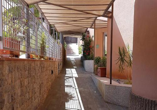 a hallway of a building with awning and plants at Addaura Village e Congressi in Mondello