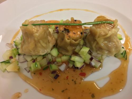 a plate of food with dumplings on a white plate at Wy & Spa in Pobierowo