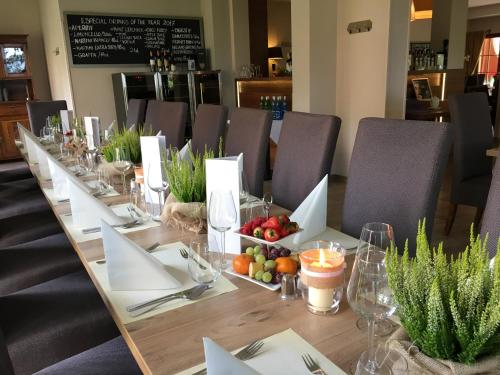 a long wooden table with fruit on top of it at Wy & Spa in Pobierowo