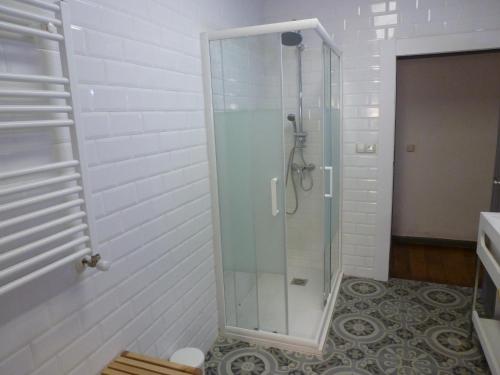 a shower with a glass door in a bathroom at Hostal del Arquitecto in Vitoria-Gasteiz