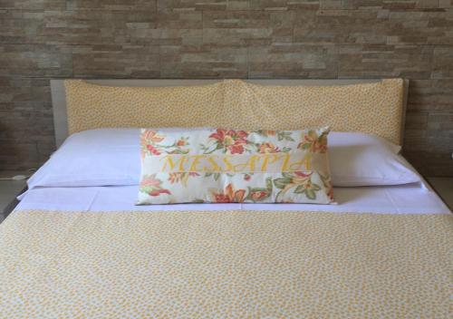 a bed with a pillow with the word missex on it at Messapia Casa Vacanze in Ugento