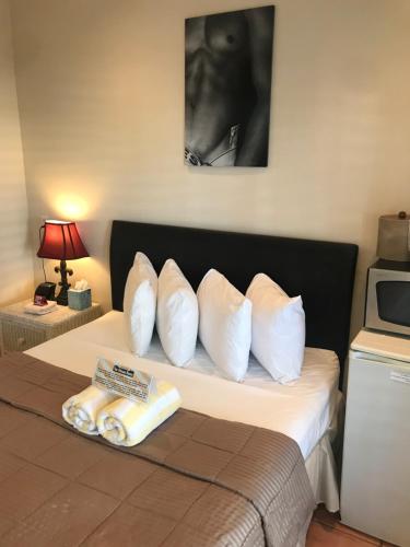 a bedroom with a bed with white pillows on it at New Orleans House - Gay Male Adult Guesthouse in Key West