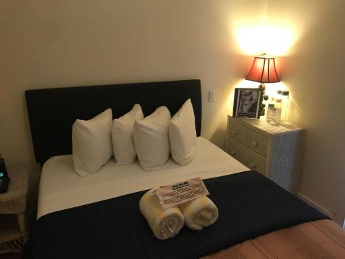 a bed with white pillows and two towels on it at New Orleans House - Gay Male Adult Guesthouse in Key West