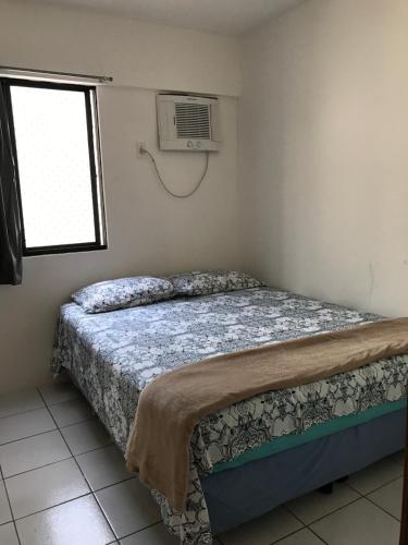 Rúm í herbergi á Apartamento Augusto Lucena