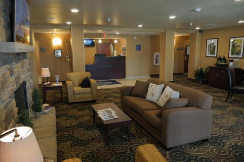 a living room with a couch and a chair at Cobblestone Inn & Suites-Winterset in Winterset