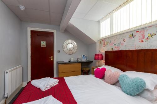 a bedroom with a bed with two hearts on it at Adelaide Lodge - Town Centre - Opposite Winter Gardens in Blackpool