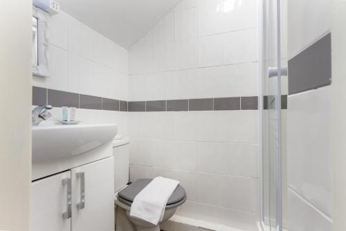 a white bathroom with a toilet and a sink at Adelaide Lodge - Town Centre - Opposite Winter Gardens in Blackpool