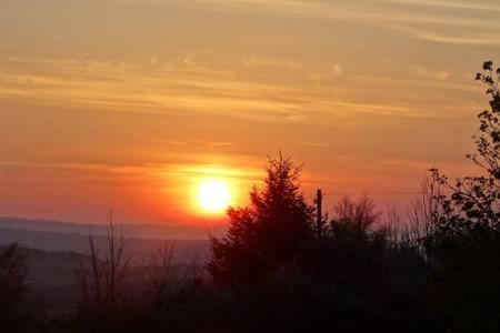 a sunset with the sun setting in the distance at Ardenlee Self Catering Apartment in Borve