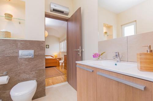 a bathroom with a toilet and a sink at Villa Casia in Mokošica