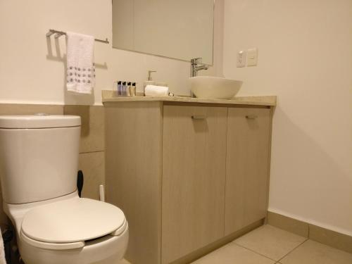 y baño con aseo blanco y lavamanos. en Boutique Apartment Carso Alameda-1102, en Ciudad de México